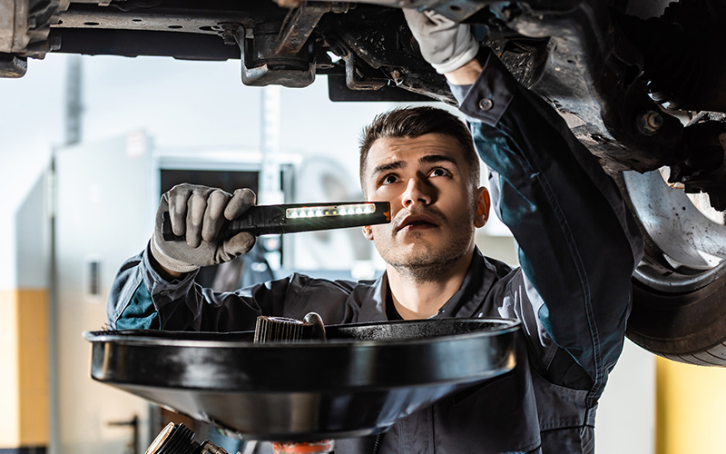 Mechanic checking under vehicle